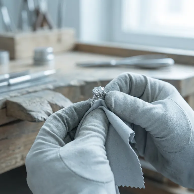 A jeweller polishing a diamond ring at the Duvaire atelier