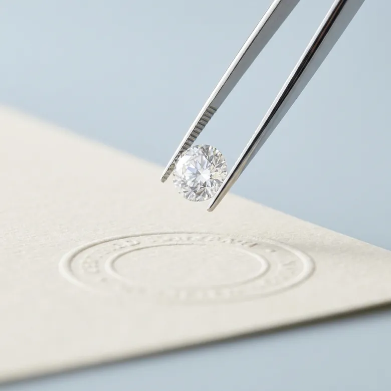 An IGI-certified lab-grown diamond inspected under a loupe